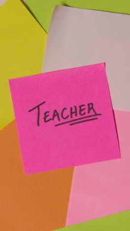 Vertical-Video-Education-Concept-Of-Revolving-Sticky-Notes-With-Teacher-Written-On-Top-Note